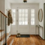Organized home entryway with furniture and storage near the door