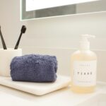 Organized bathroom counter with towel and personal-care items