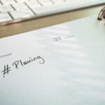 Weekly planner and keyboard on a desk