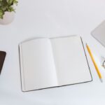 Notebook and planning tools on a desk used to choose important tasks