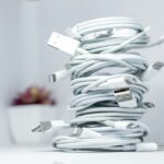Smartphone charging setup with cables organized on a desk