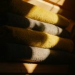 Linen closet with folded towels and bedding arranged on shelves