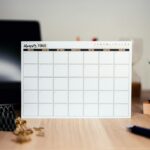 Paper calendar on a desk beside digital planning tools