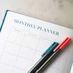 Notebook and calendar on a desk for reviewing goals and the next quarter
