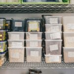 Storage bins arranged on shelving for comparing visible and concealed storage