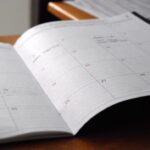 Monthly planner on a desk used to organize broad time blocks